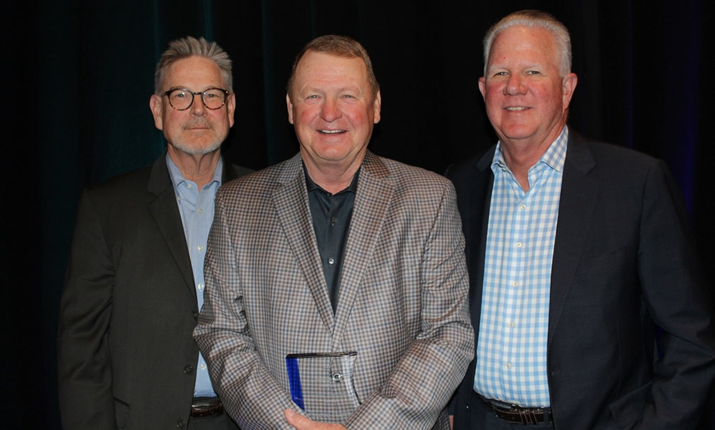 Presenting the Outstanding Service Award to Susan Cunningham (center) was Tom Zacharias (left), President, National Crop Insurance Services, and Mike Day (right), Chairman of the National Crop Insurance Services Board of Directors.