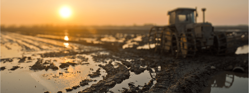 Tractor in muddy field